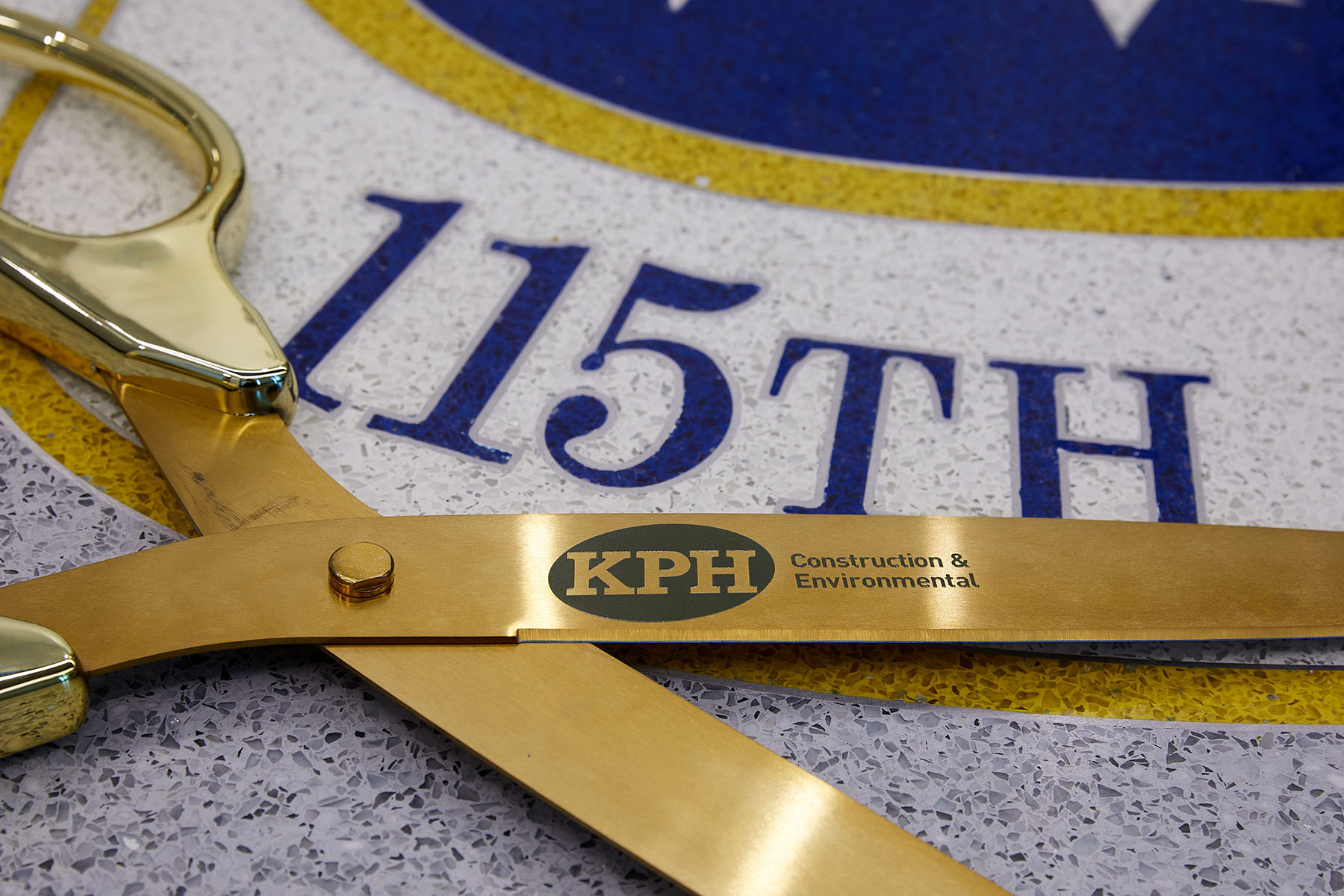 a pair of golden scissors on a white surface