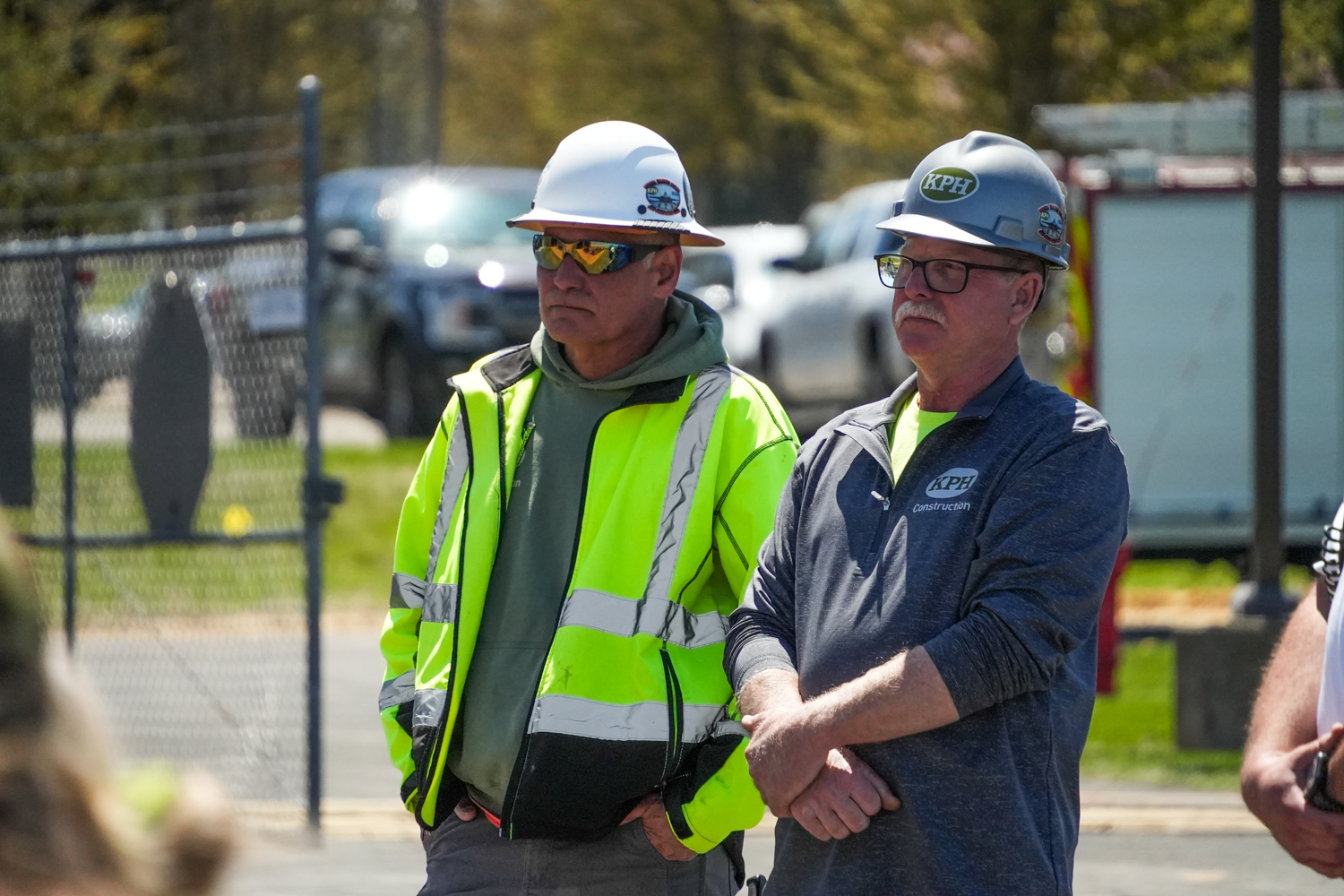 a group of men wearing hardhats and reflective jackets