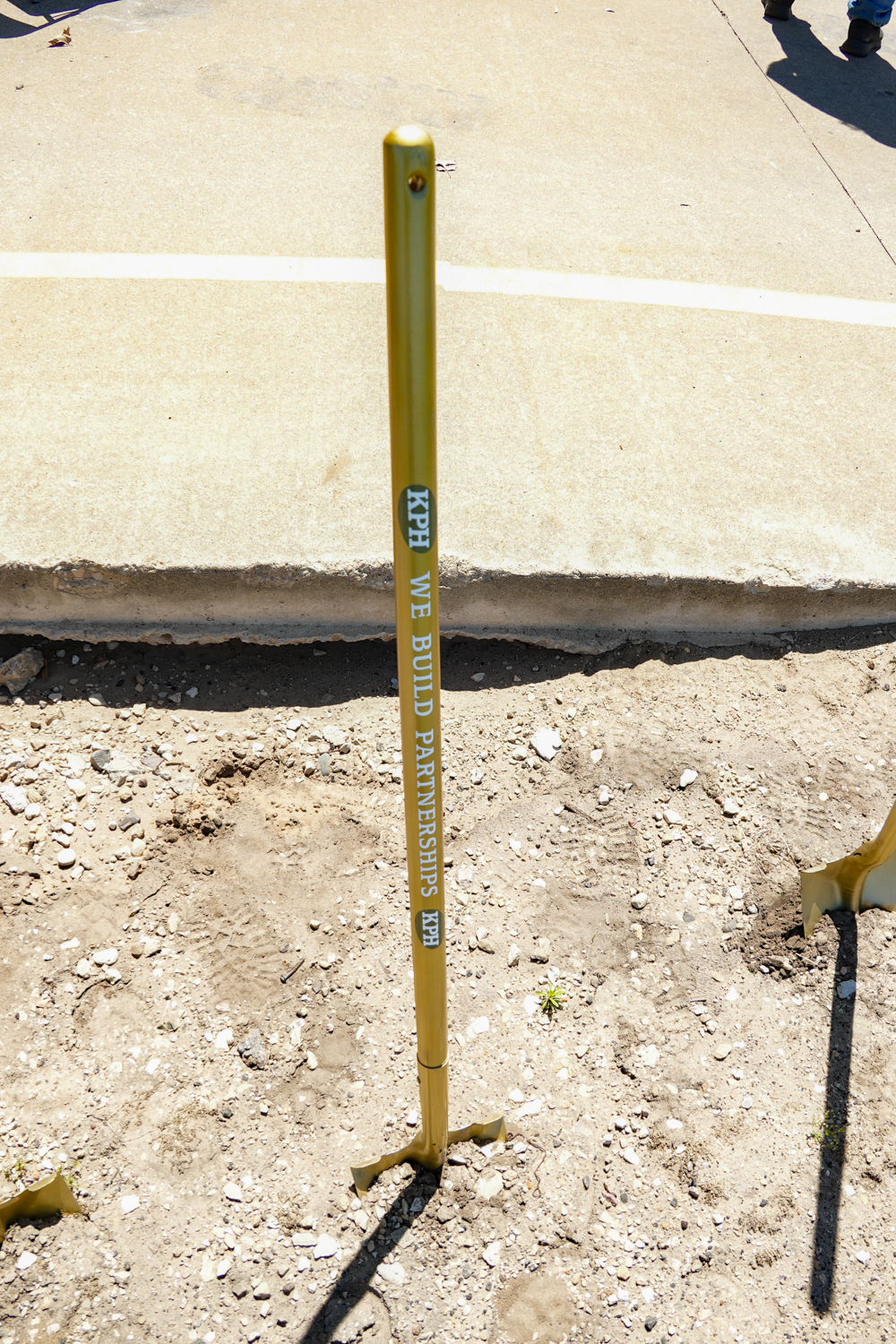 a yellow pole in dirt