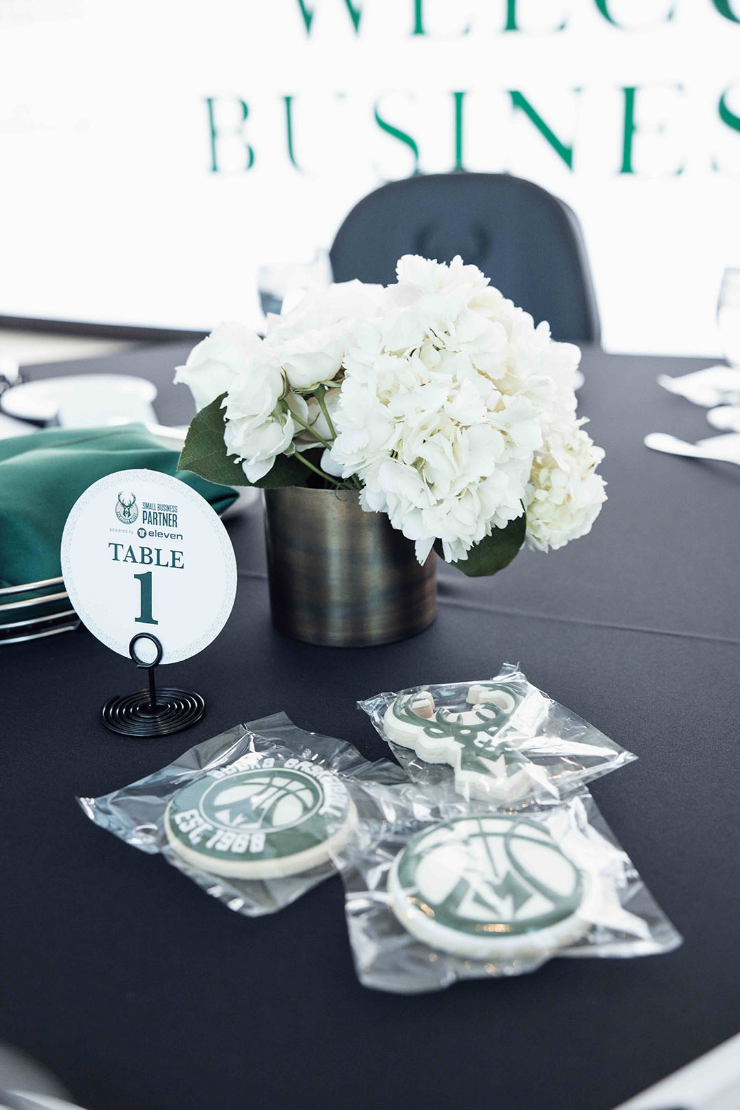 a table with white flowers and cookies